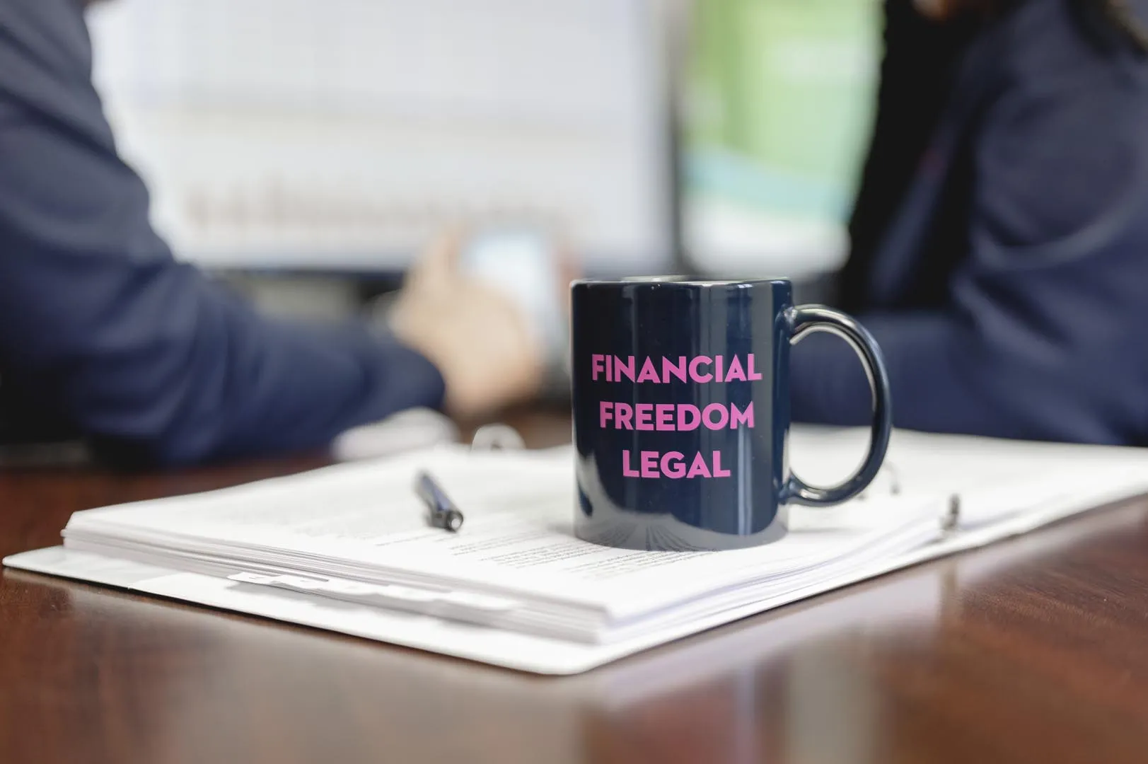 Bankruptcy attorneys negotiating with coffee mug in the foreground